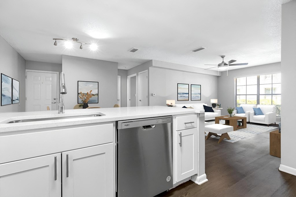 an open kitchen and living room with a large counter top