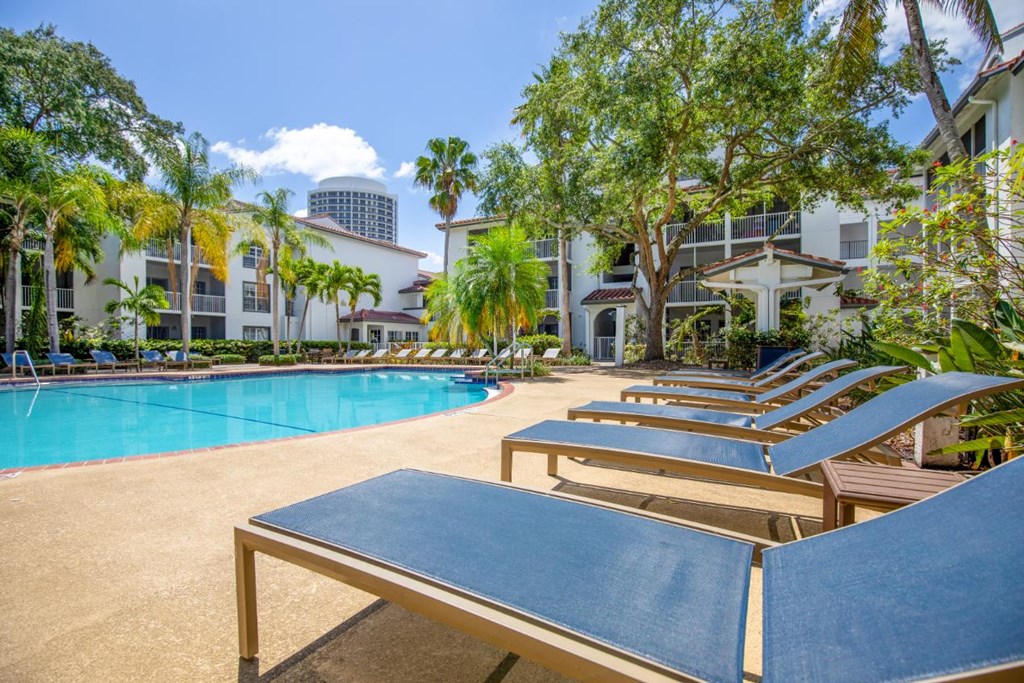 a group of tables sitting around a swimming pool