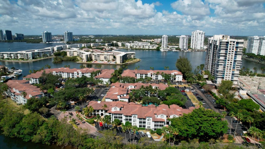 an aerial view of a city with a lake and buildings