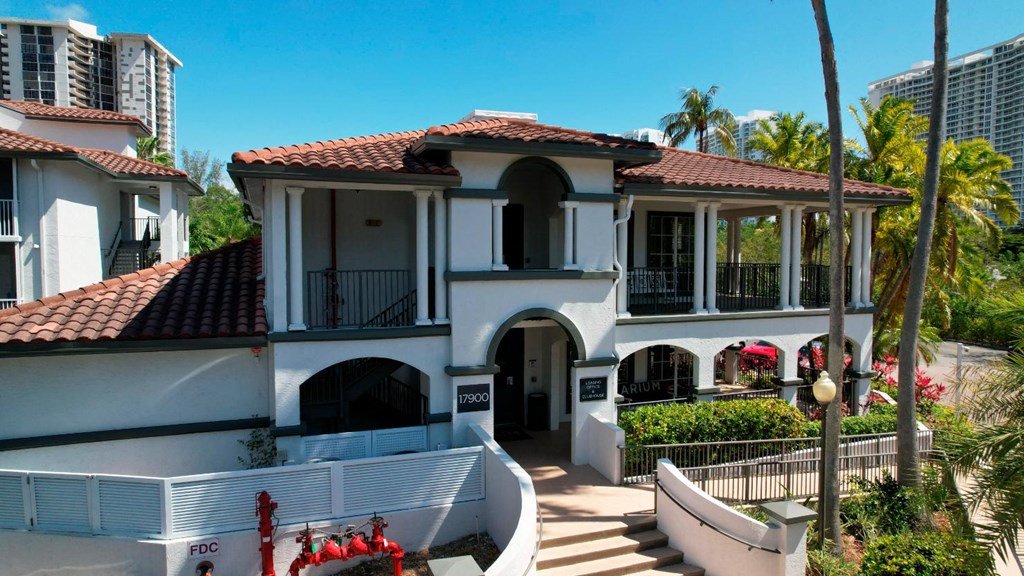 a house with a swimming pool in front of a building