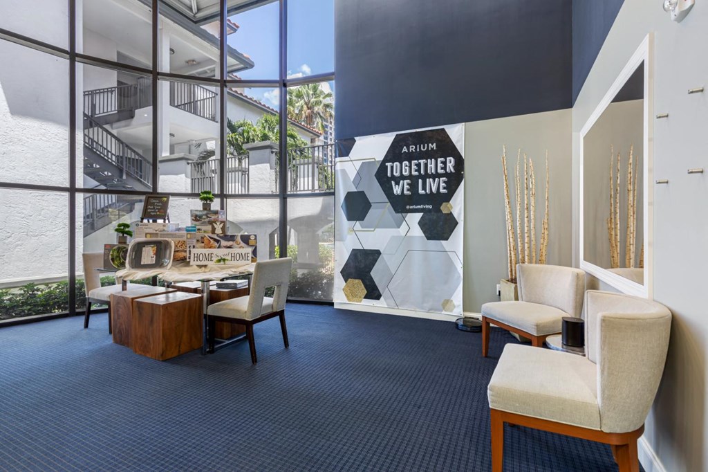 a lobby with a table and chairs and a wall with a mural