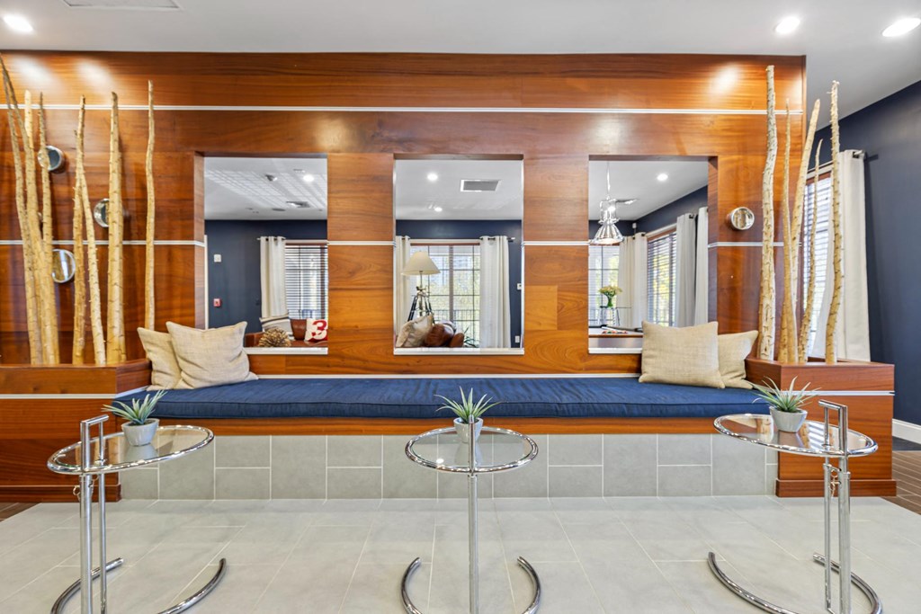 a living room with a blue couch and two tables