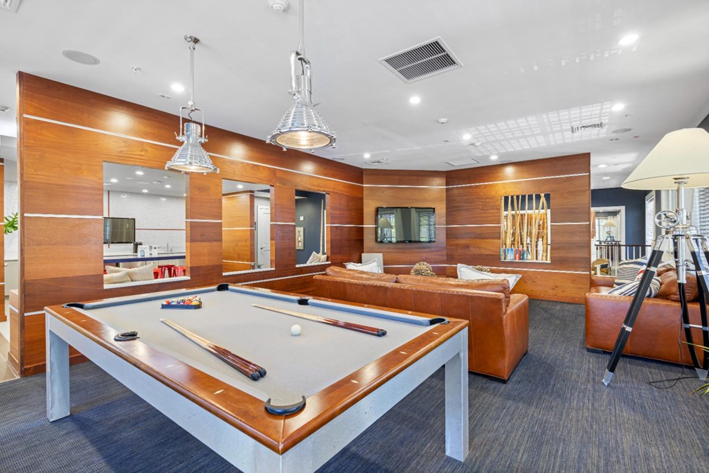 a pool table is in the center of a living room