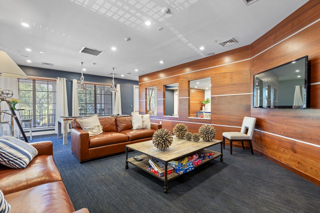 a living room with leather couches and a coffee table