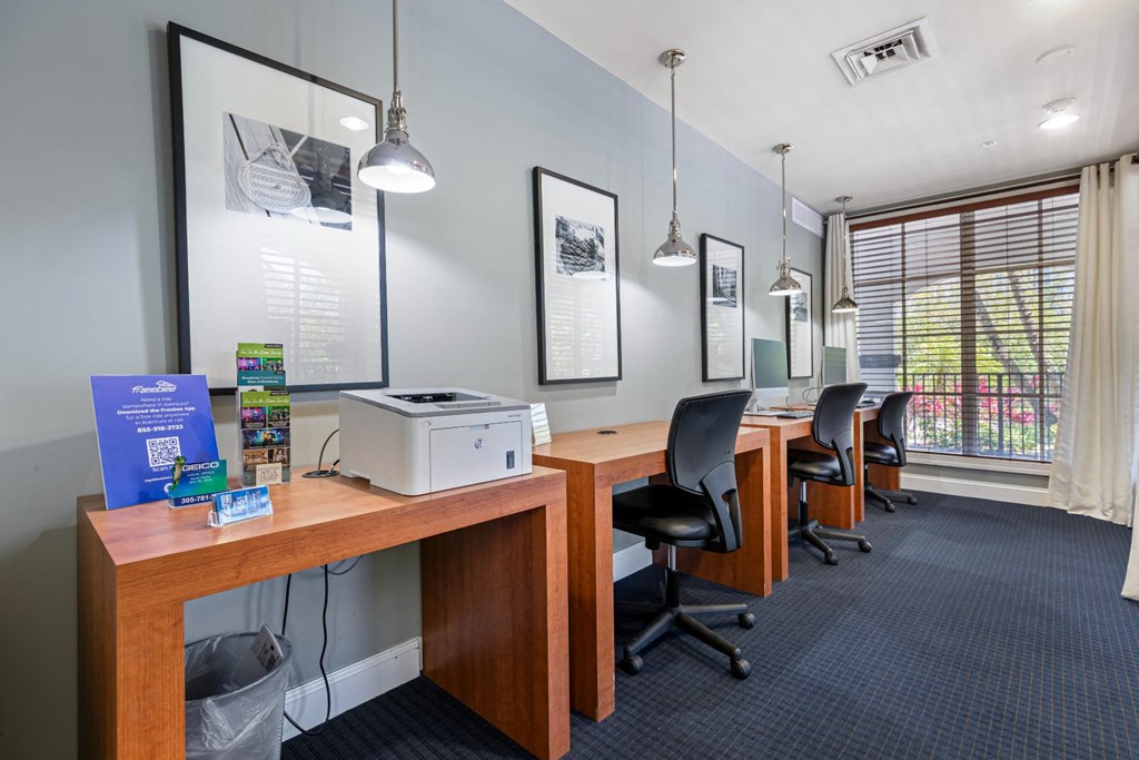 a conference room with desks and chairs and a printer