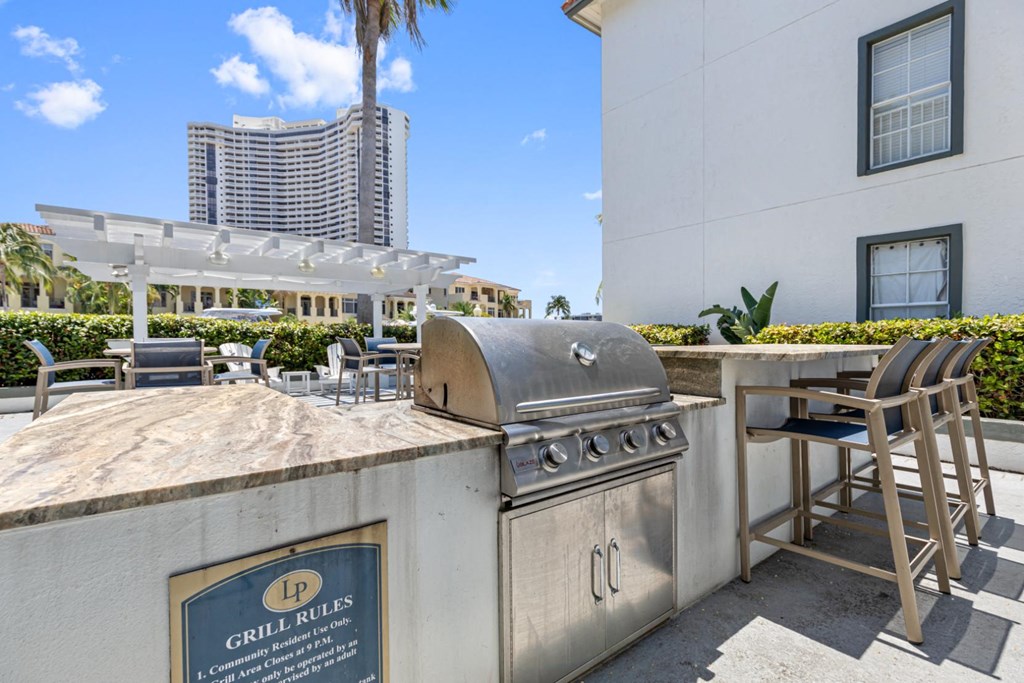 a bar with a grill and a table with high chairs