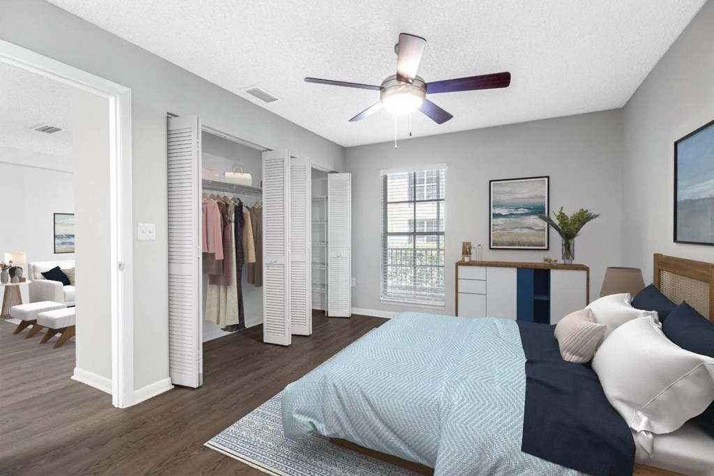 an open bedroom with a bed and a ceiling fan