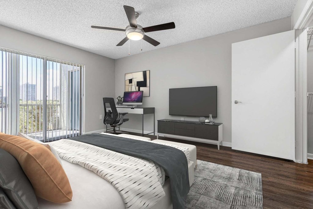 a bedroom with a large bed and a ceiling fan