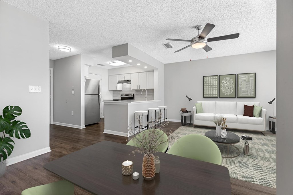 an open living room and kitchen with a dining table