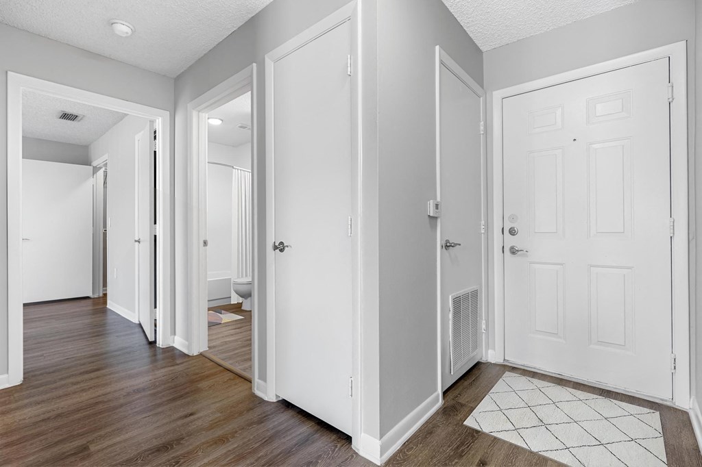a renovated living room and hallway with white doors