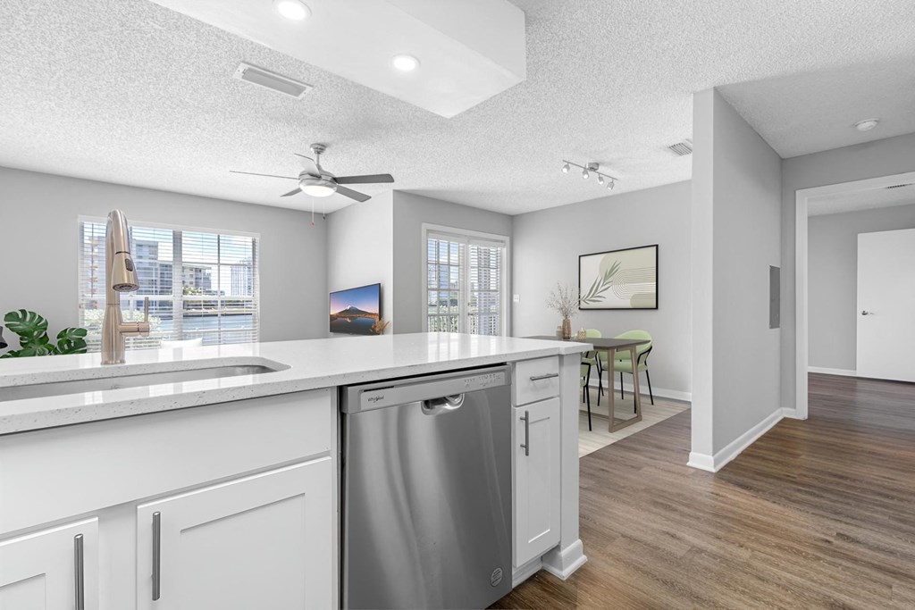 an open kitchen and living room with a large counter top