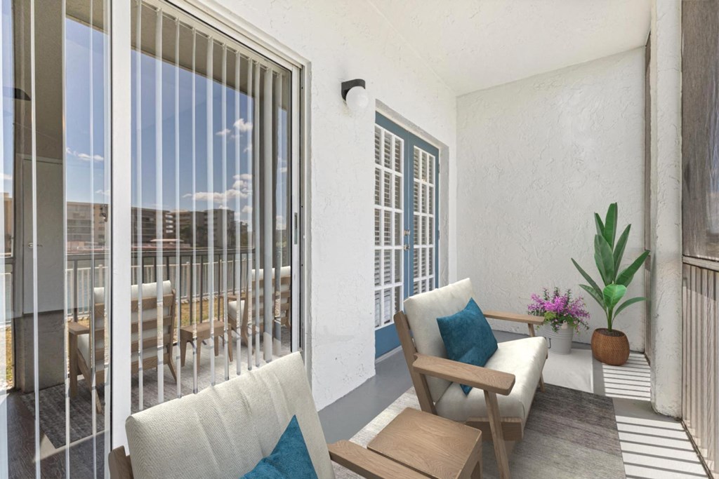 a living room with a couch and chairs and a balcony