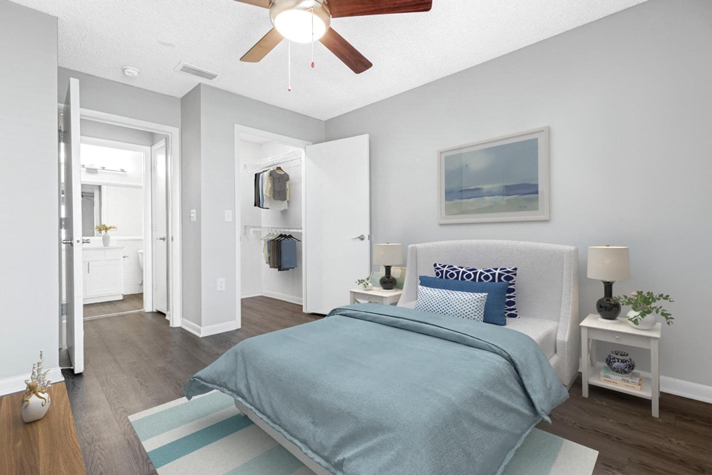 a bedroom with a bed and a ceiling fan