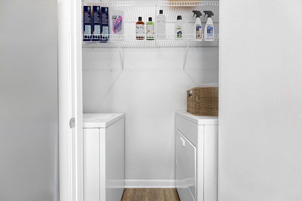 a small walk in closet with a washer and dryer