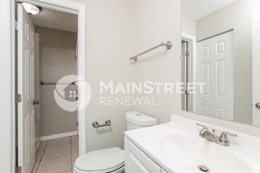 a small bathroom with a sink and a toilet and a mirror