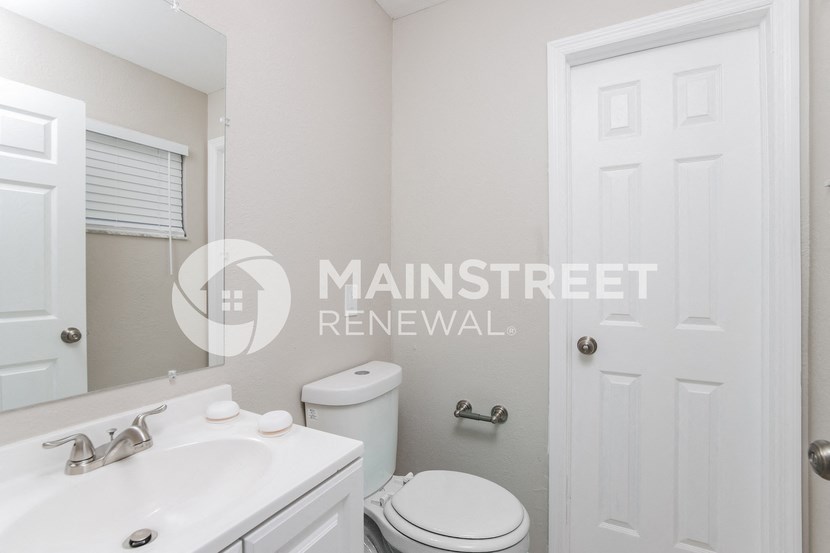 a small white bathroom with a toilet and a sink