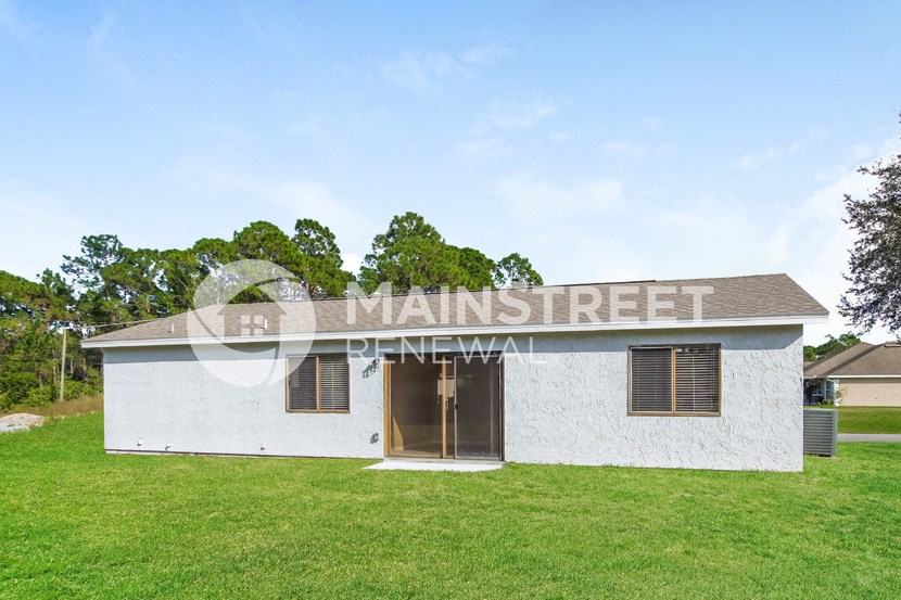 a small white building with the words manistee street on the front of it