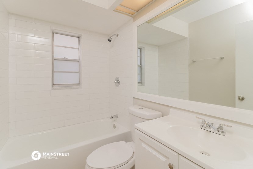 a white bathroom with a sink toilet and a tub