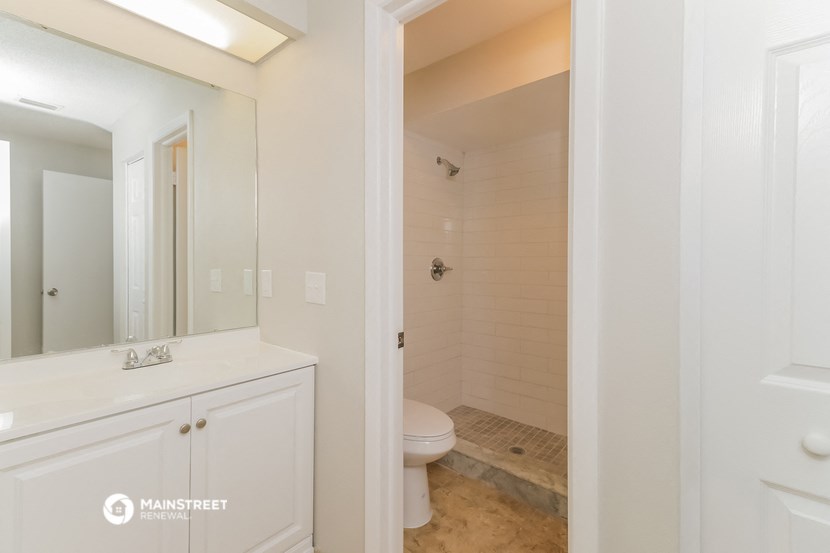 a bathroom with a toilet and a sink and a mirror