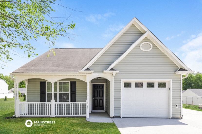 the front of a house with a white garage door