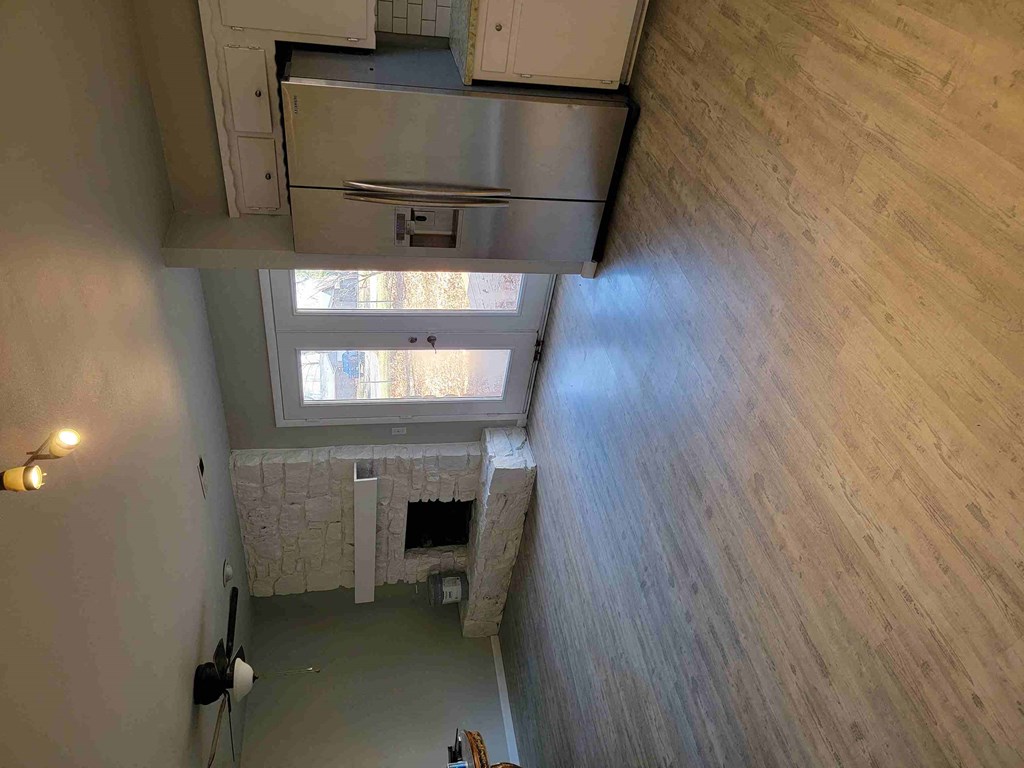 a view from the top of a bathroom looking down into a room with a window