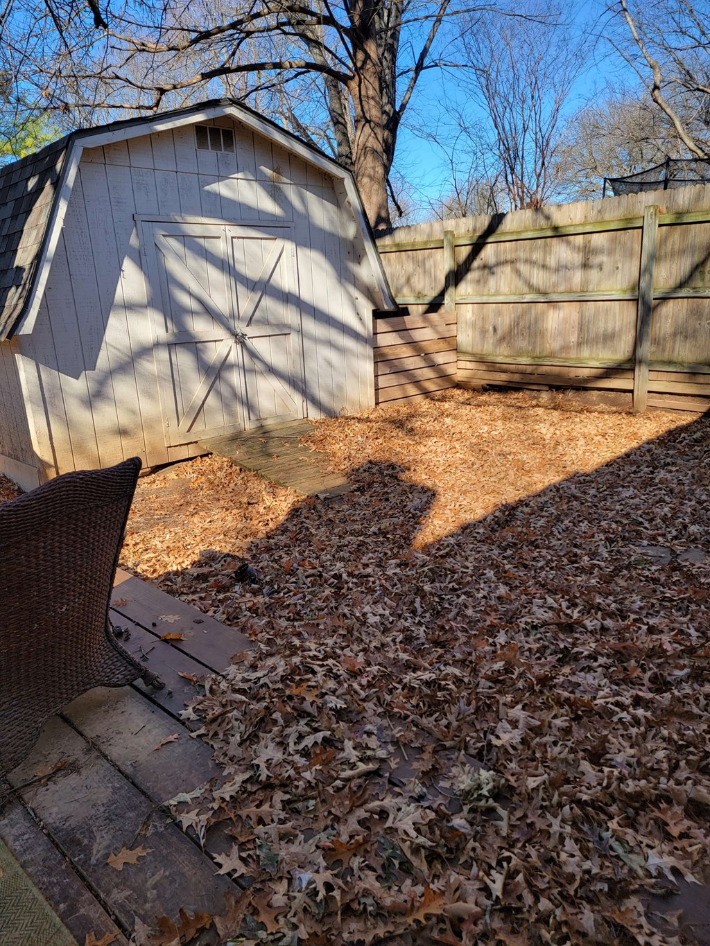 a backyard with a shed and a chair