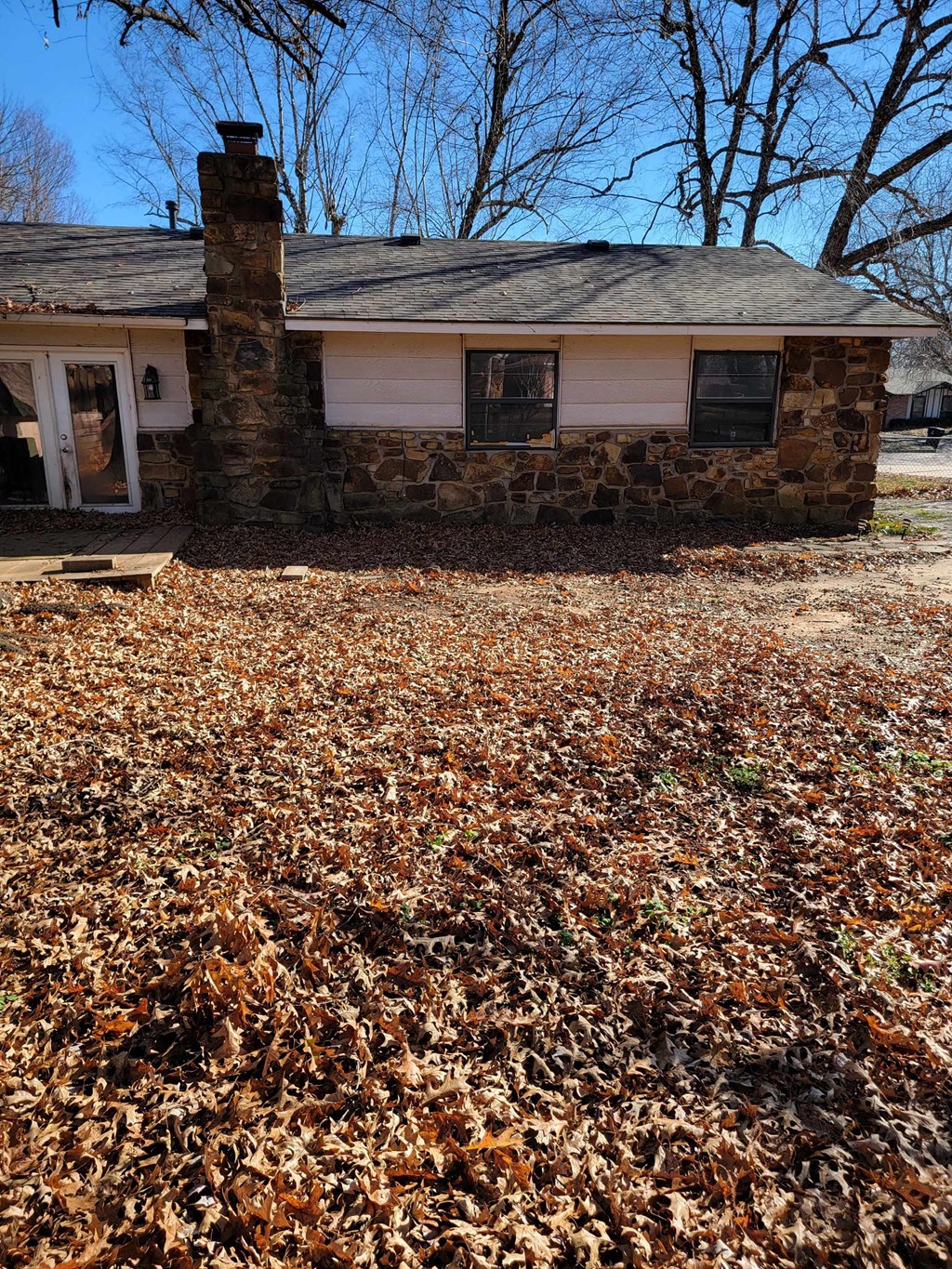 a house in the fall with leaves on the ground