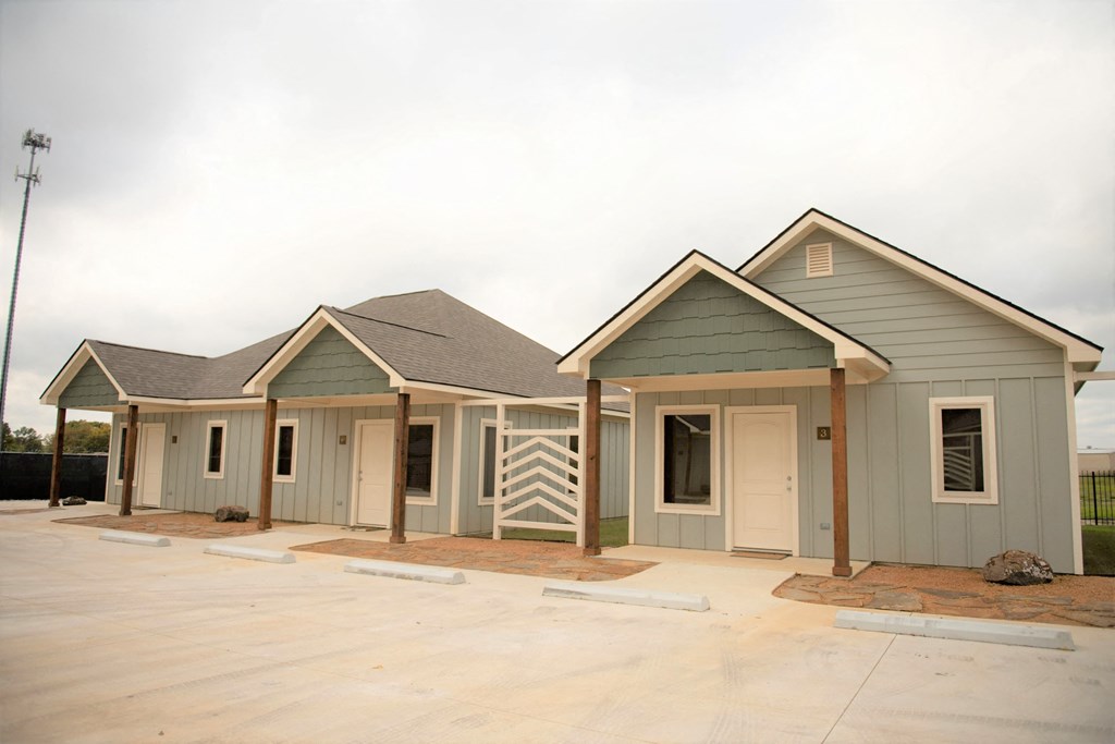 three new manufactured homes in a row with a sky background