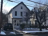 A house with a car parked in front.