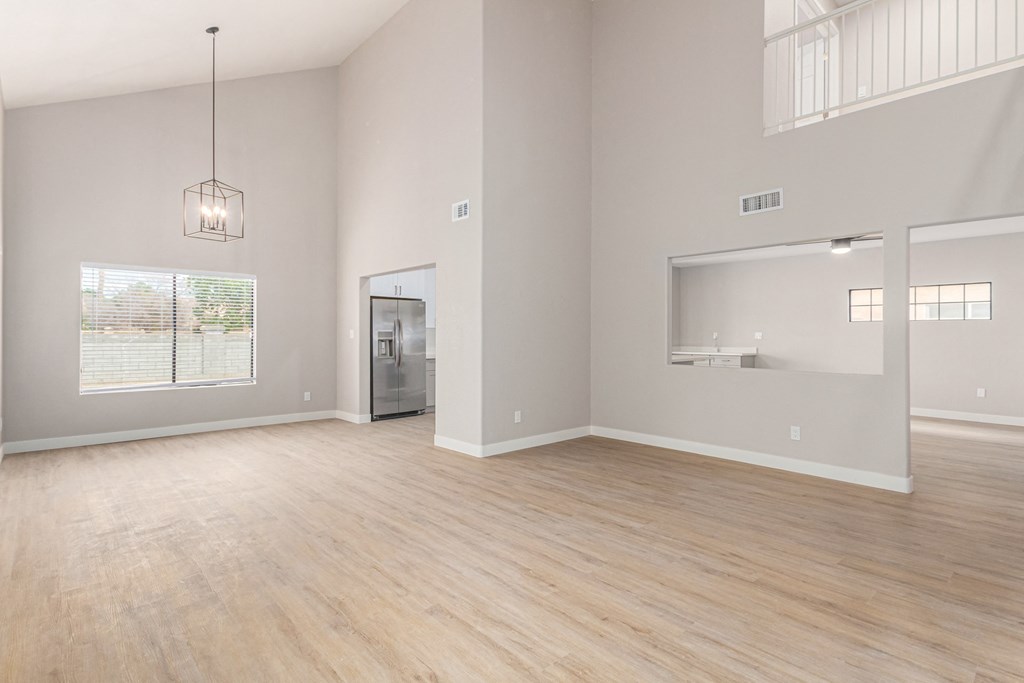 the living room and dining room with the kitchen in the background