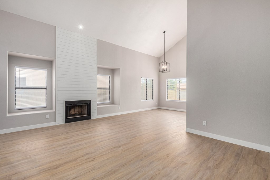 a living room with a fireplace and a hard wood floor