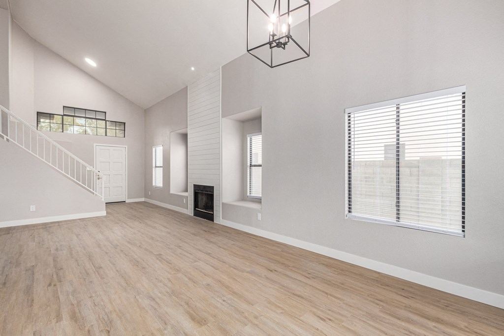 the living room and dining room of a new home with a large window