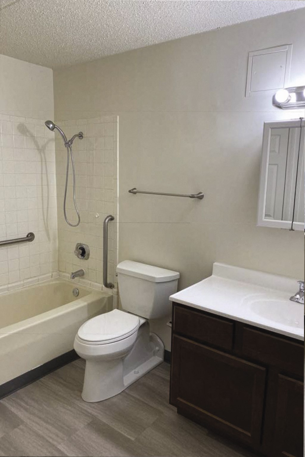 a bathroom with a toilet and a tub and a sink