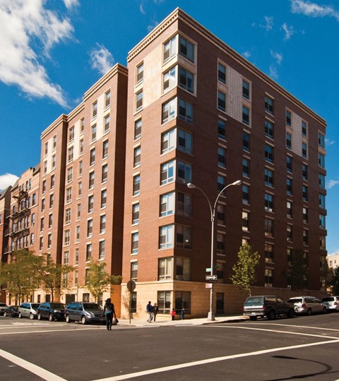 a large brick building on the corner of a city street