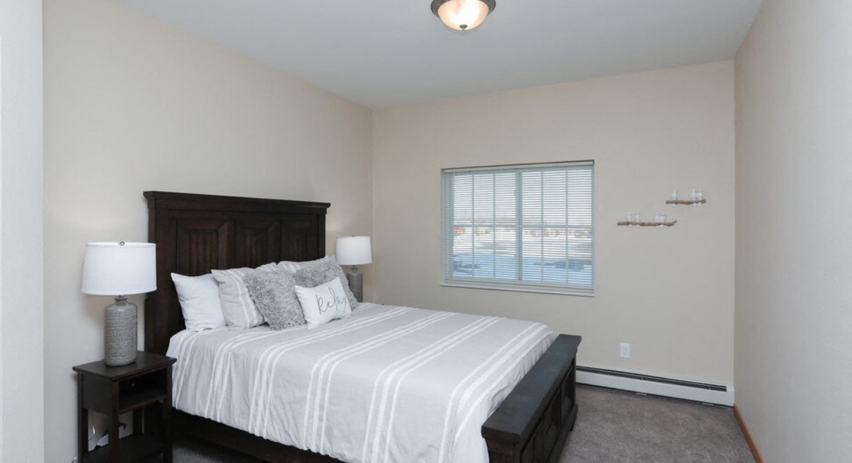 a bedroom with a large bed and a window