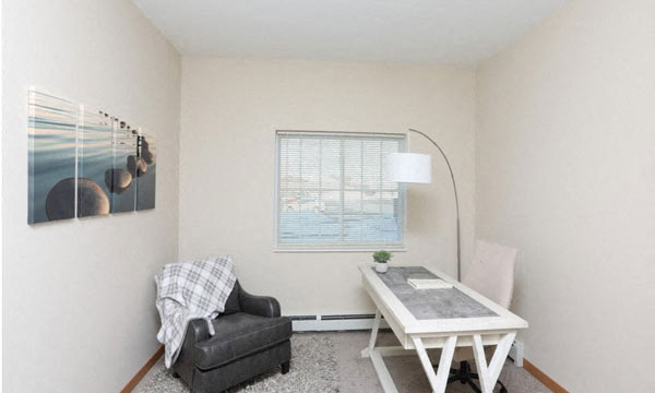 a living room with a couch and a table and a window