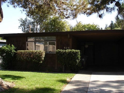 A house numbered 936 with a green lawn in front.