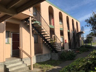 the front of a building with stairs and a