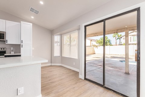 A kitchen with white cabinets and a countertop with a microwave and oven.