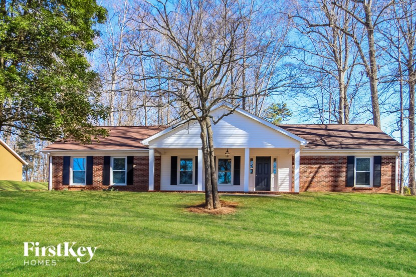 A house with a tree in front of it.