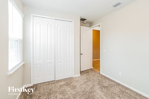 a bedroom with two closets and a door to a hallway