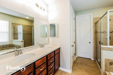 a bathroom with two sinks and a large mirror