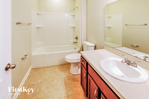 a bathroom with a sink and a toilet and a shower