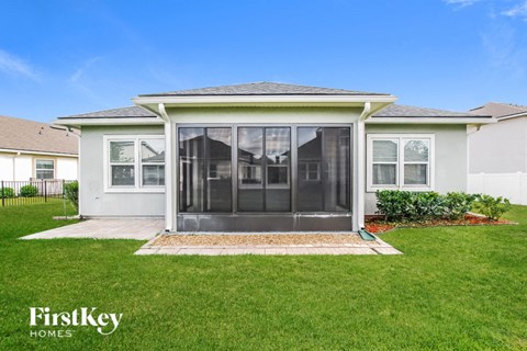 a white house with a lawn and a patio