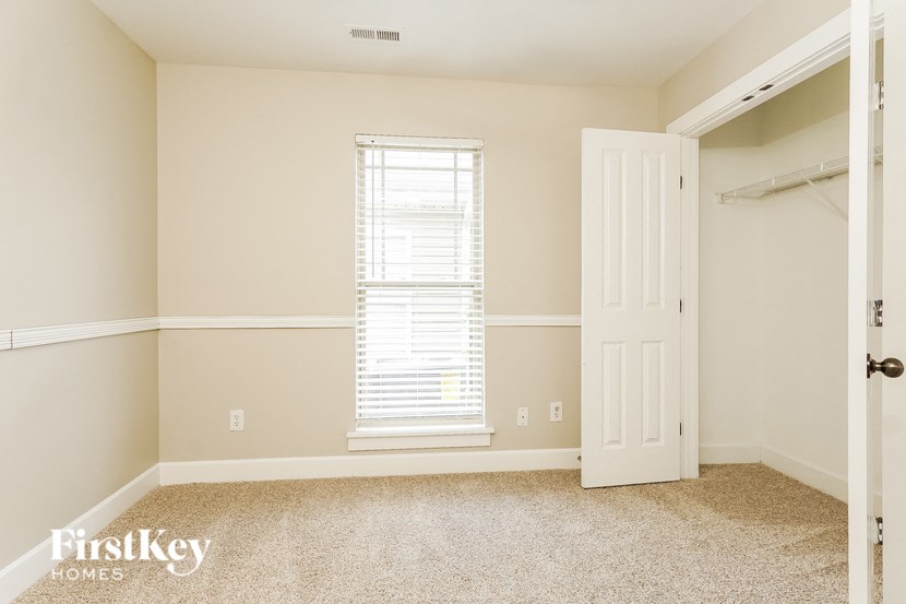 A room with a window and a door is shown.