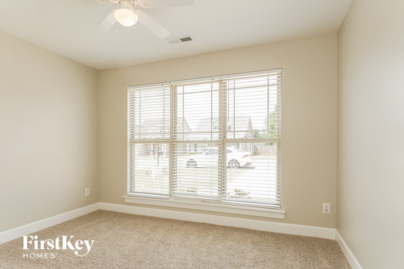 A room with a car parked outside the window.