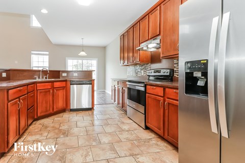 an updated kitchen with stainless steel appliances and wooden cabinets