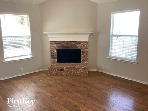 a living room with a fireplace and a wooden floor