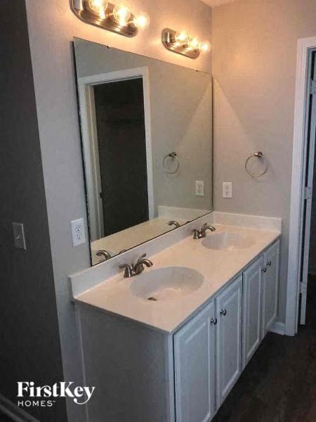 a bathroom with a white sink and a mirror
