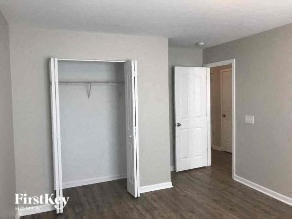 an empty room with a closet and a white door